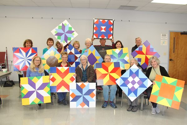 Barn quilt class posing with their paintings